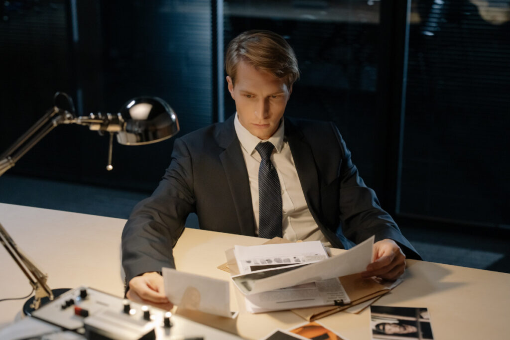 man studying documents at desk